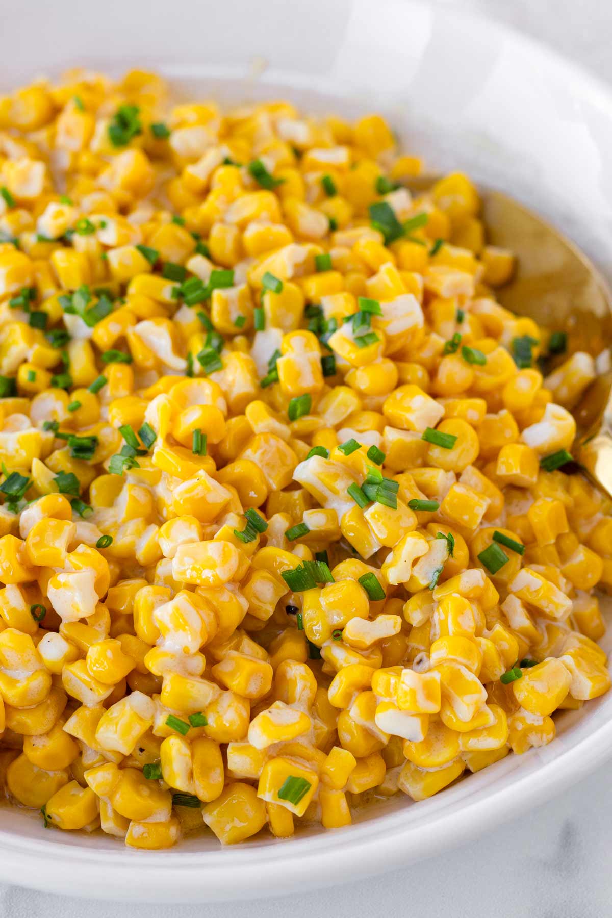 garnished creamy corn with cream cheese, butter, and honey