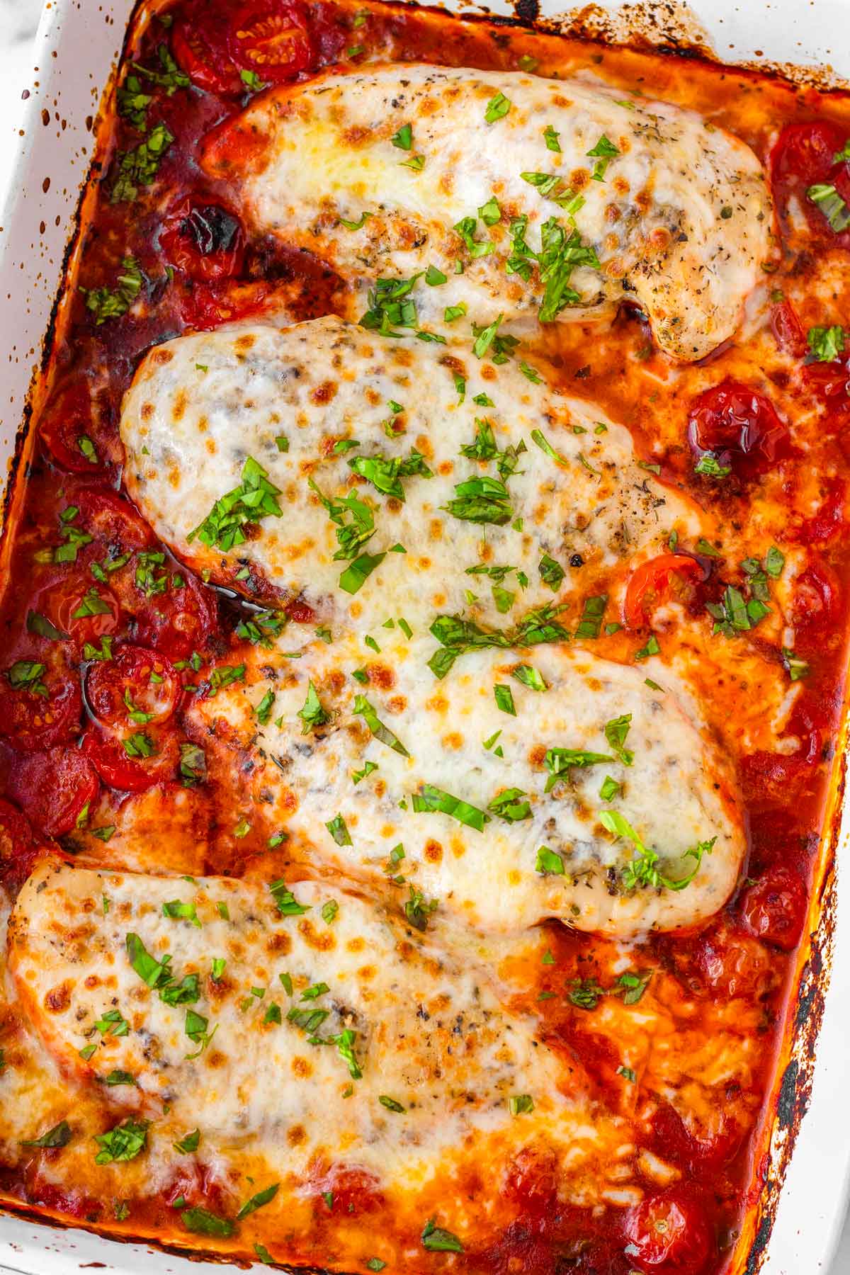 four chicken breasts with cheesy mozzarella and tomato sauce