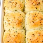 a baking pan with six garlic herb dinner rolls