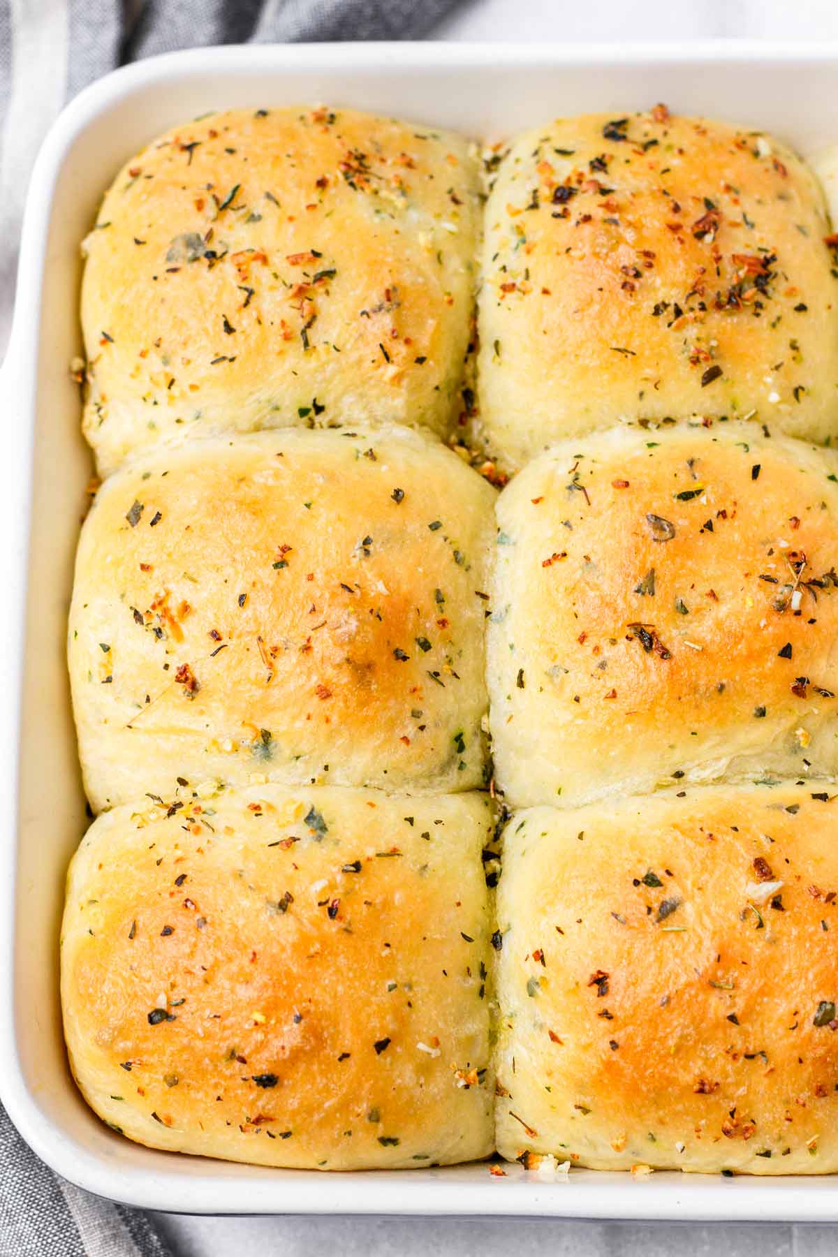 a baking pan with six garlic herb dinner rolls