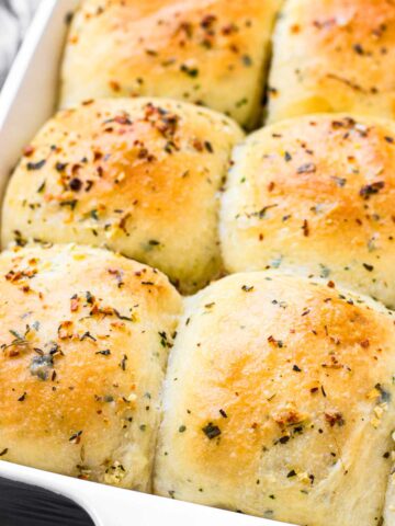 risen and baked dinner rolls with herbs