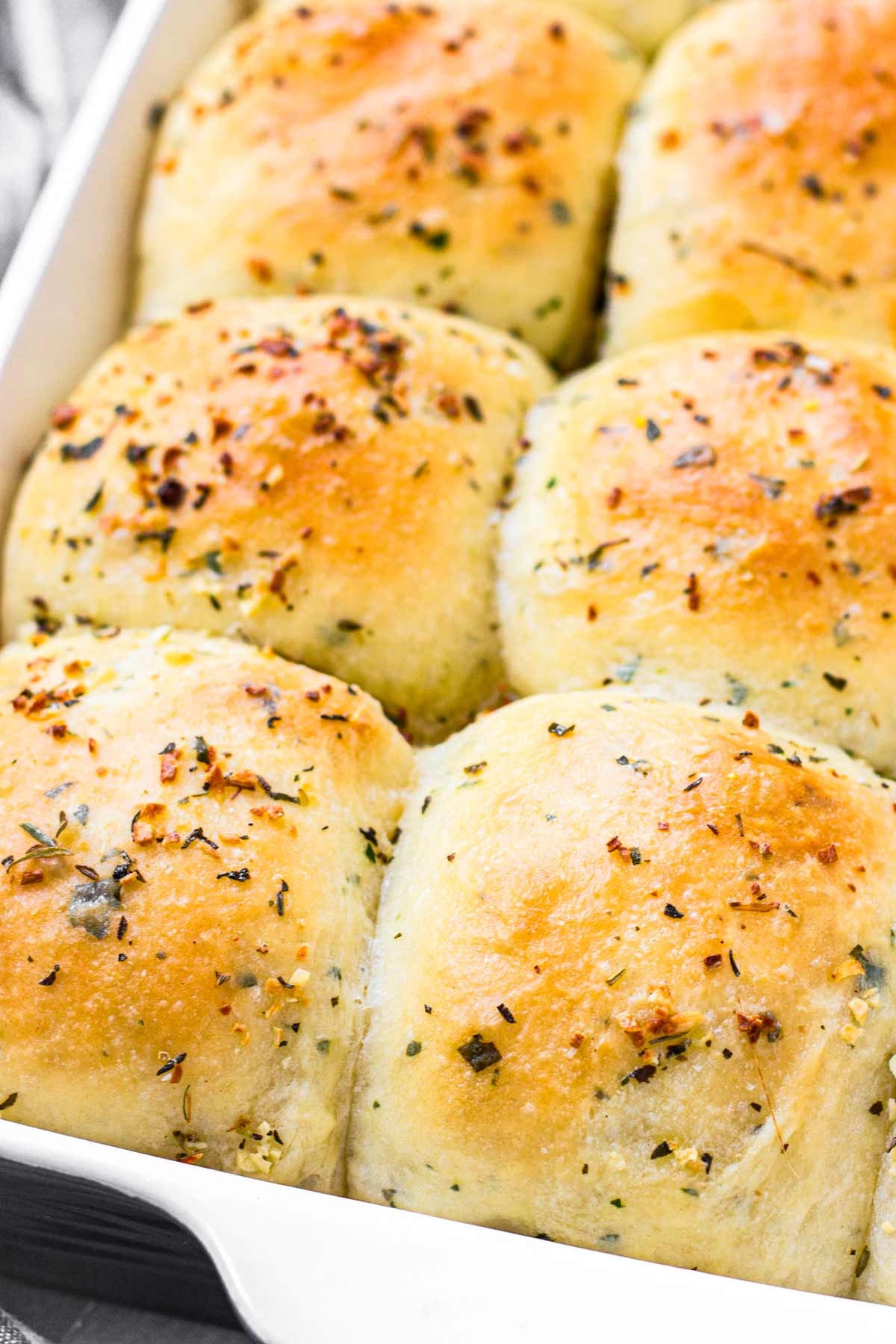 risen and baked dinner rolls with herbs