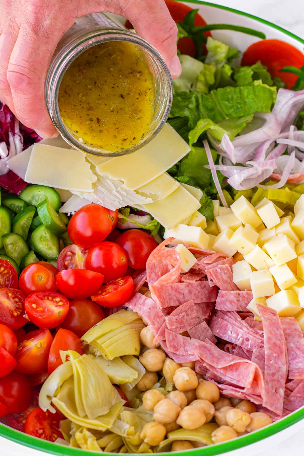 adding dressing to bowl