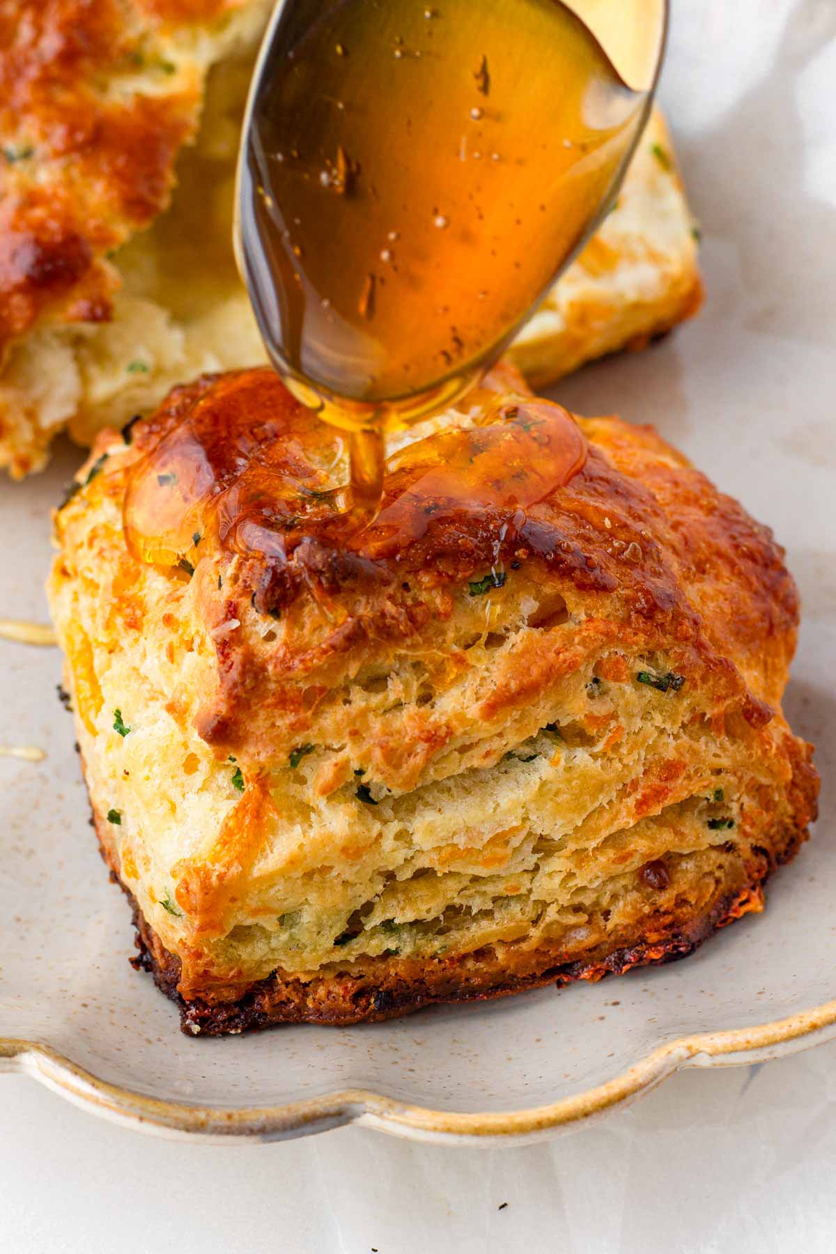 drizzling honey onto cheddar chive biscuits