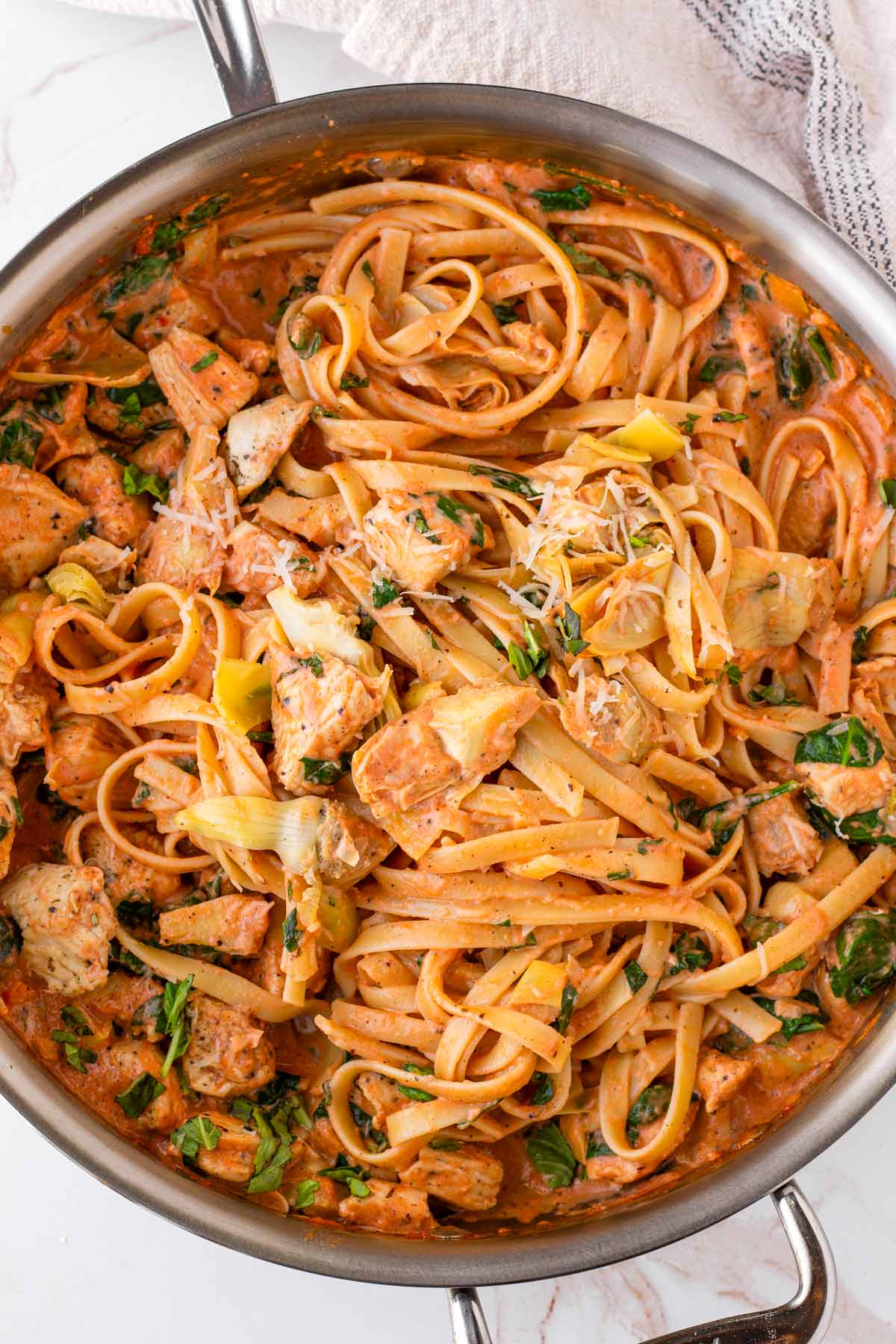 chicken artichoke pasta in skillet