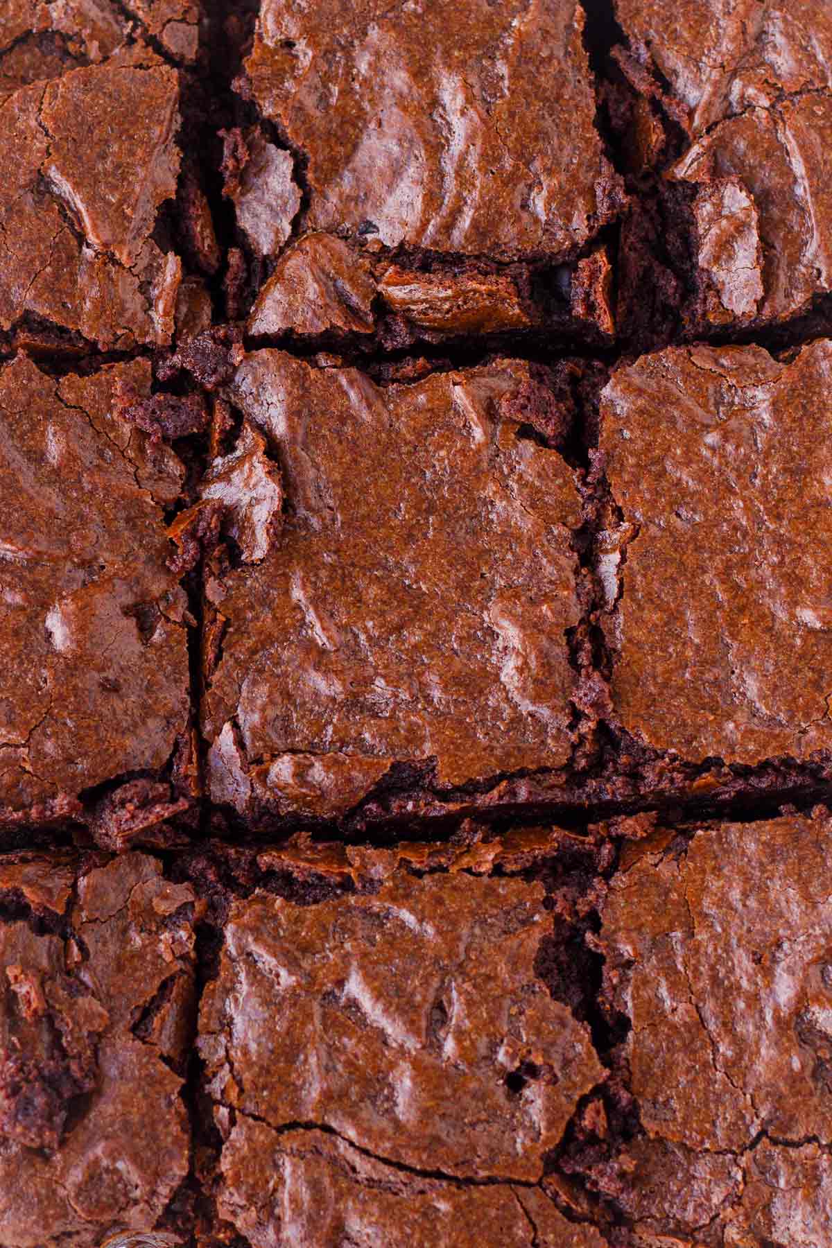 close of up sliced brownies on pan with crackly top