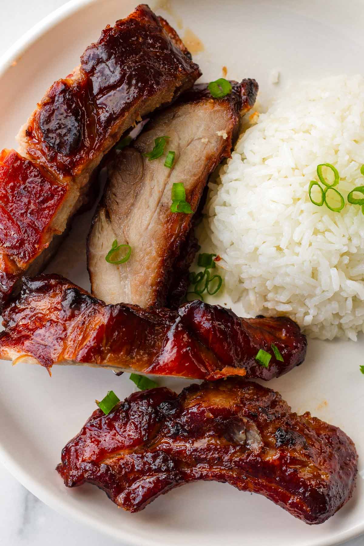 four pieces of chinese bbq ribs with rice