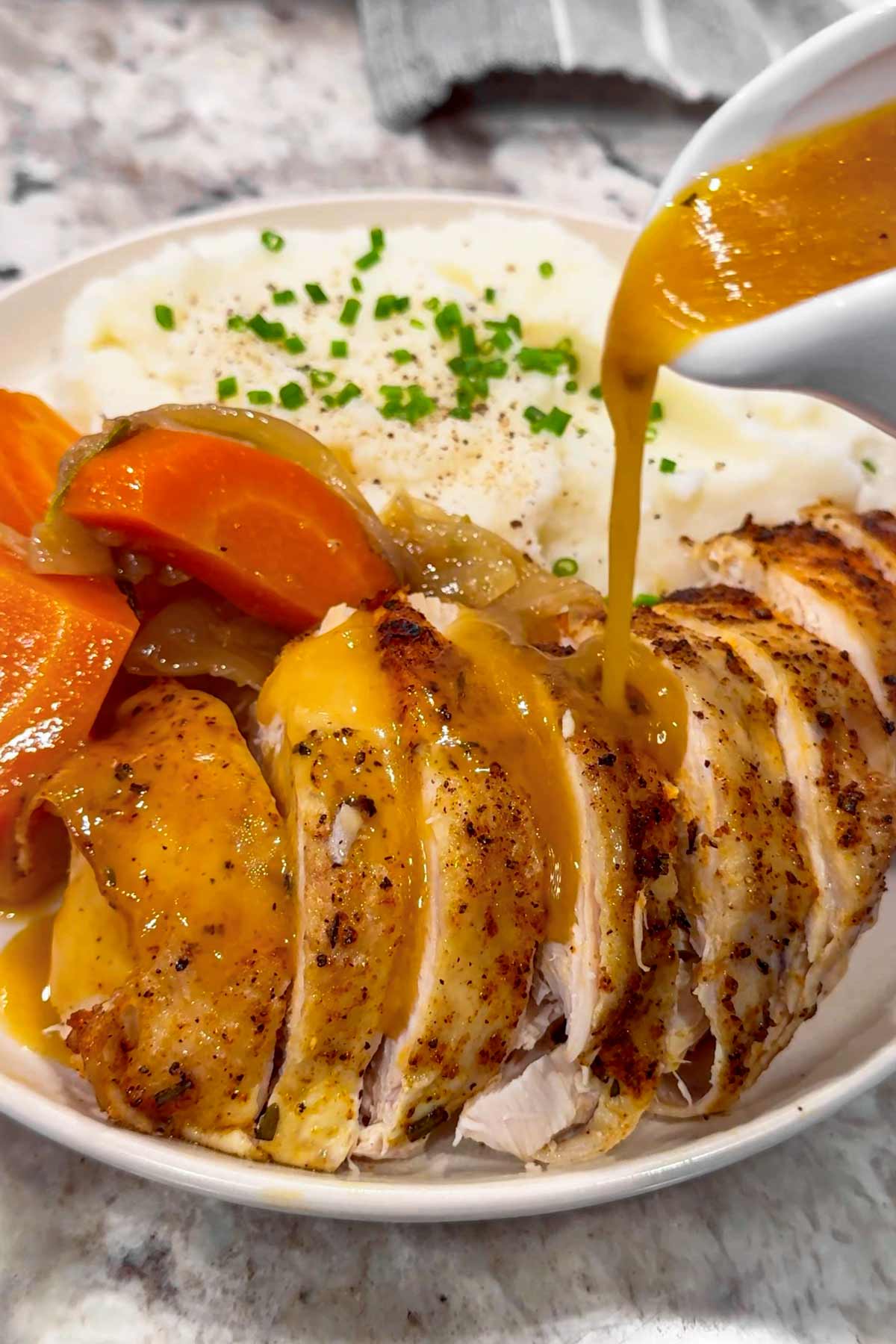 plate of slow cooker chicken breast with gravy