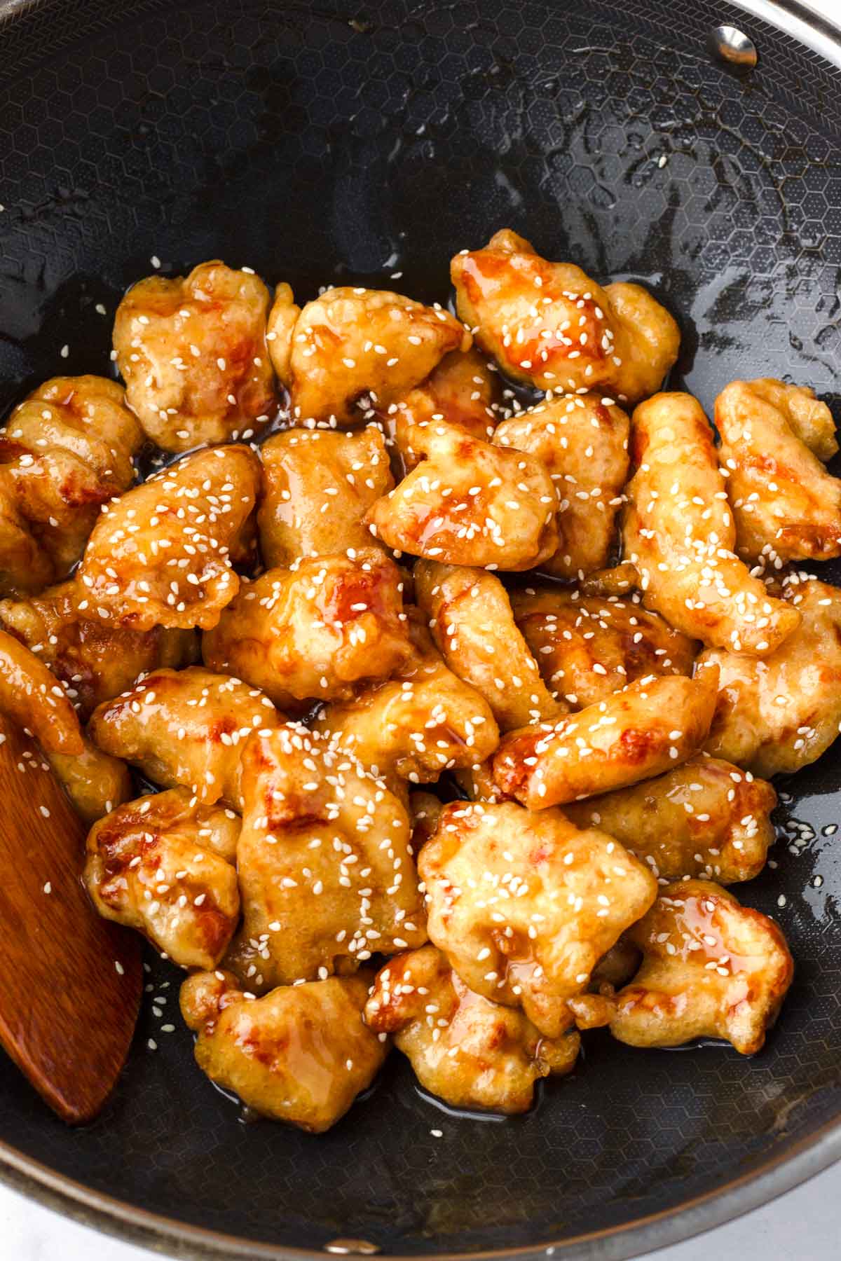 garnished honey sesame chicken in wok