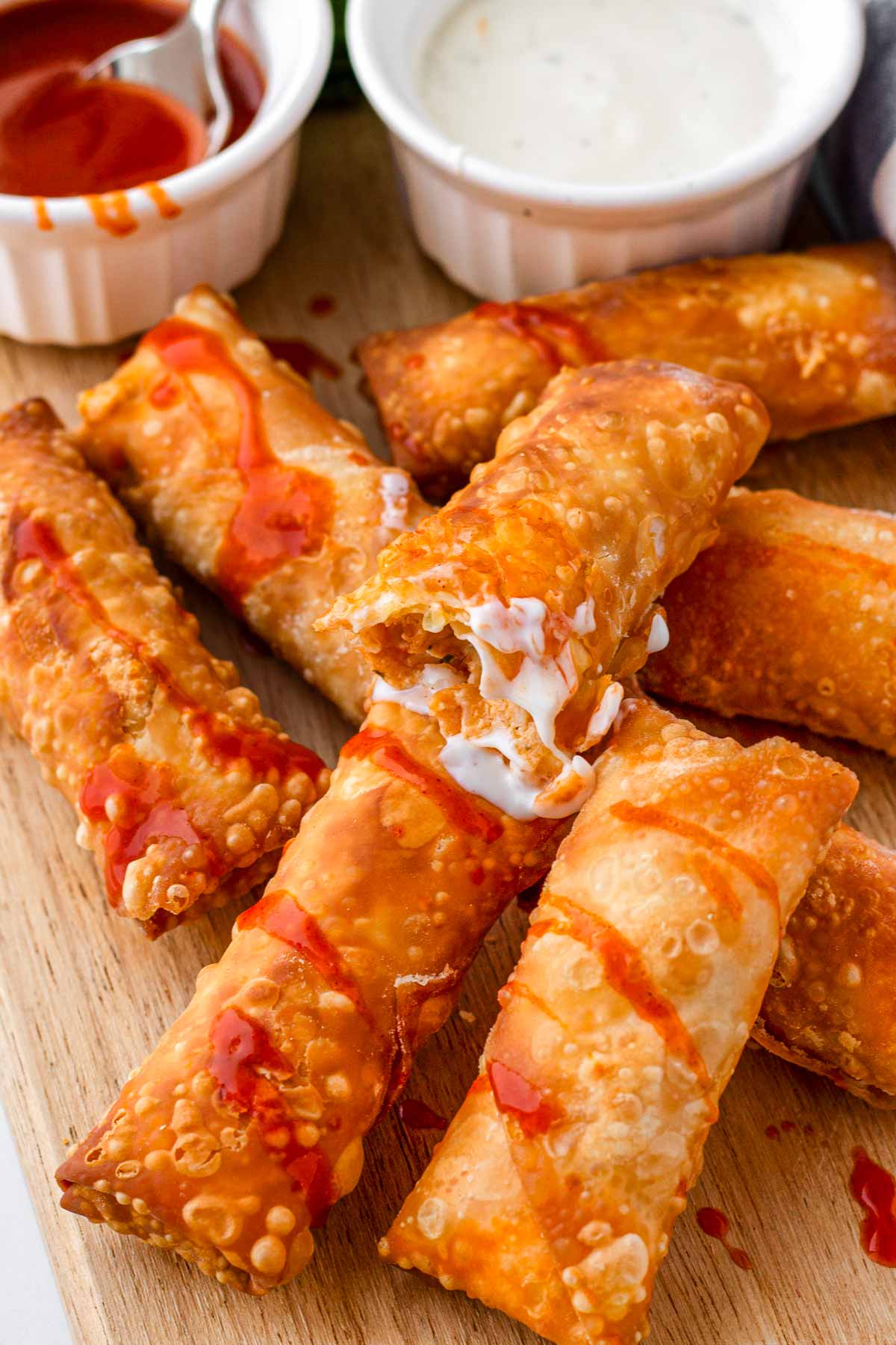 stacked chicken egg rolls with buffalo sauce