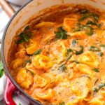 creamy tomato tortellini soup in red dutch oven