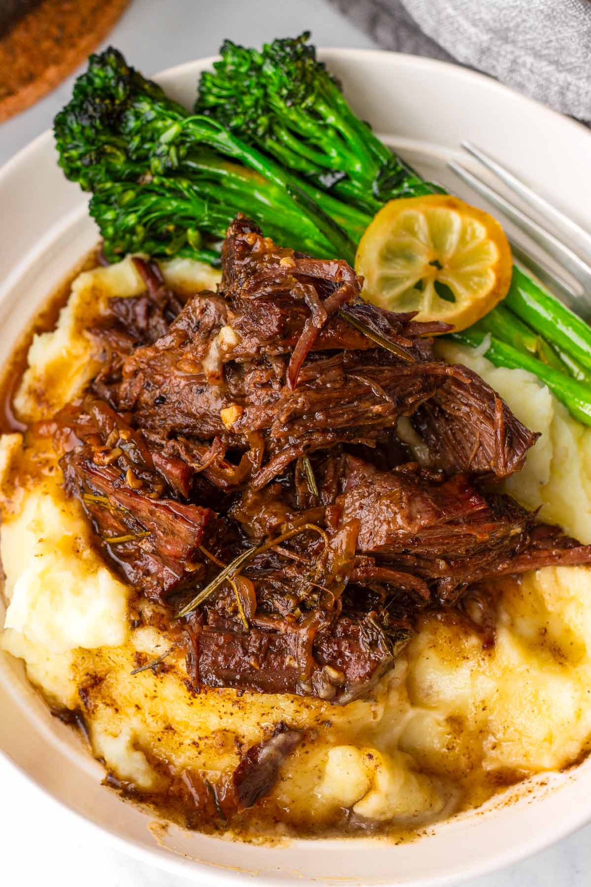 bowl of honey balsamic pot roast over mashed potatoes