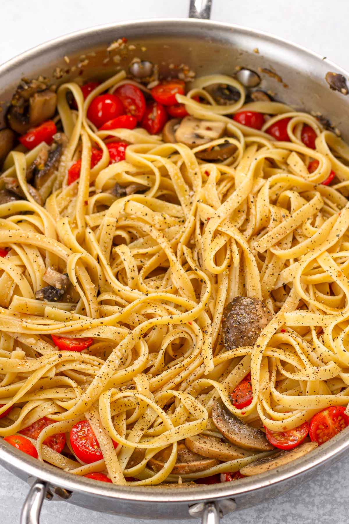 tossing with tomatoes and pasta