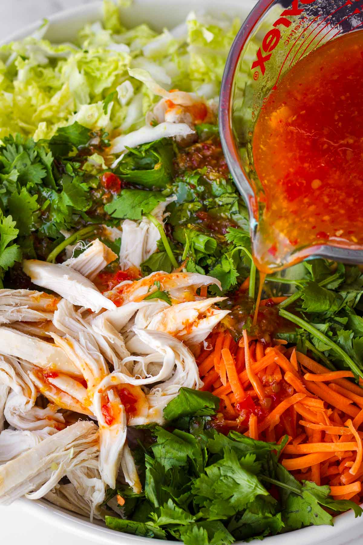 adding dressing to the bowl