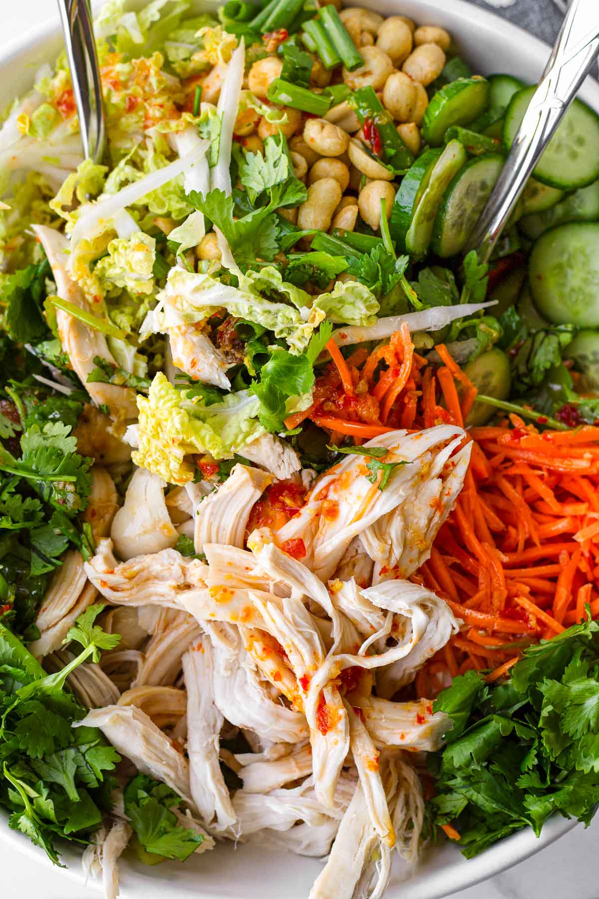 tossing dressed salad ingredients