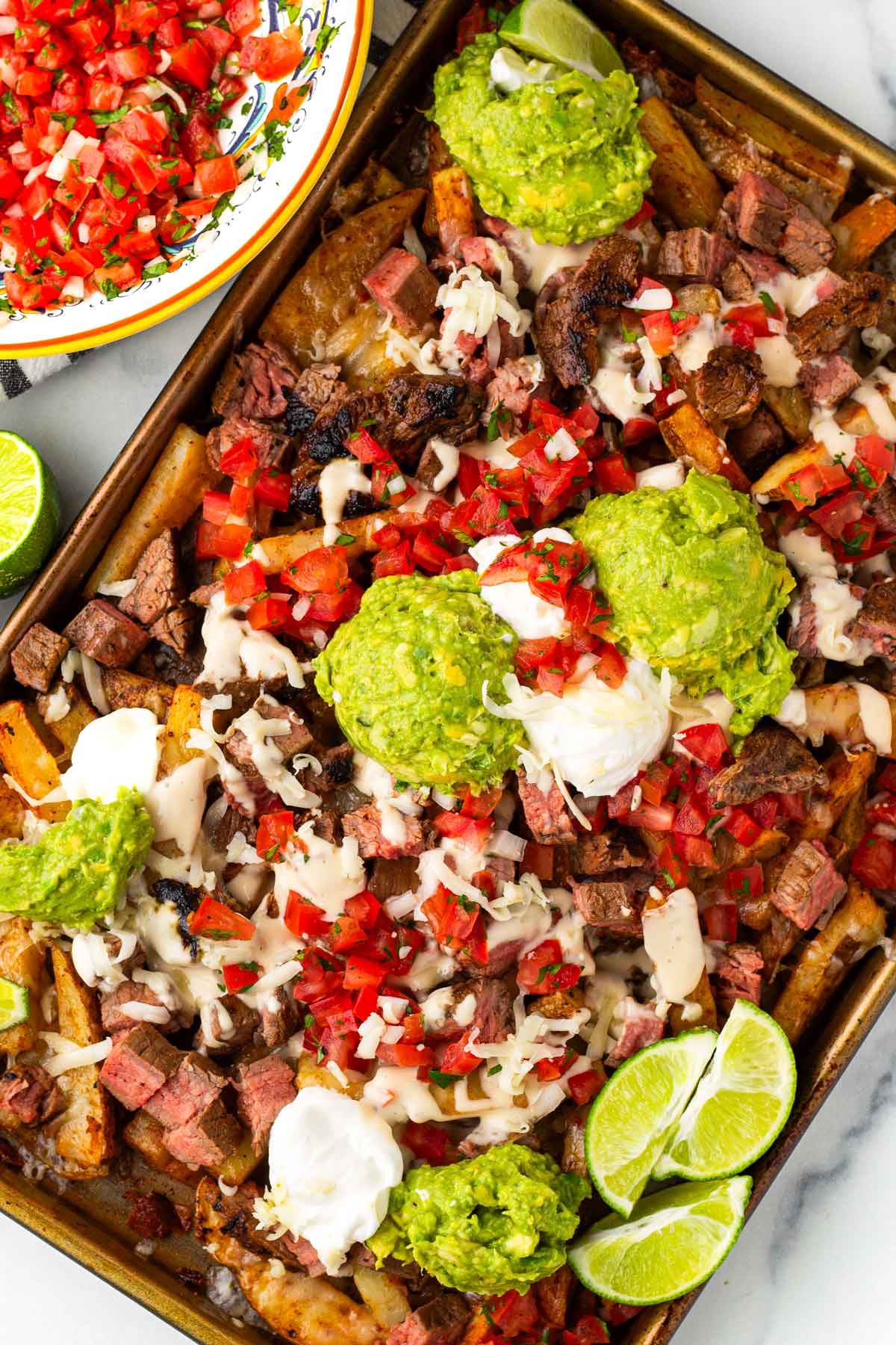 loaded carne asada fries on sheet pan