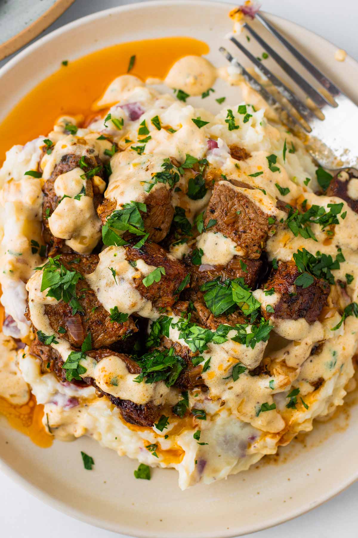 steak bites piled high on top of mashed potatoes