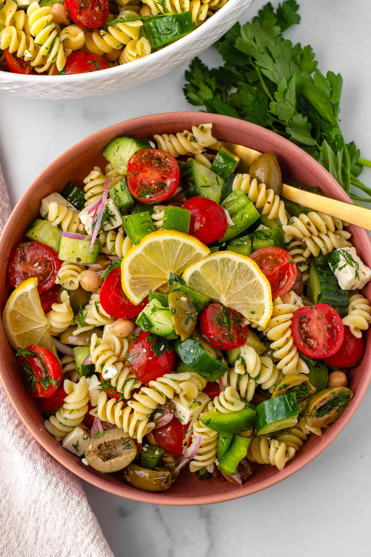 bowl of greek pasta salad with garnish