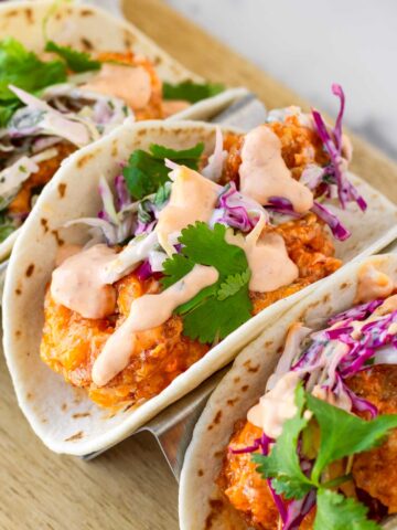 bang bang shrimp tacos on a taco holder