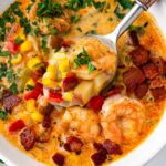 a spoonful of corn chowder with shrimp