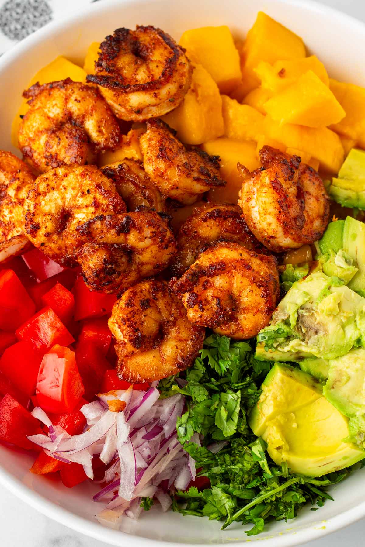 assembled ingredients for the mango shrimp salad in bowl