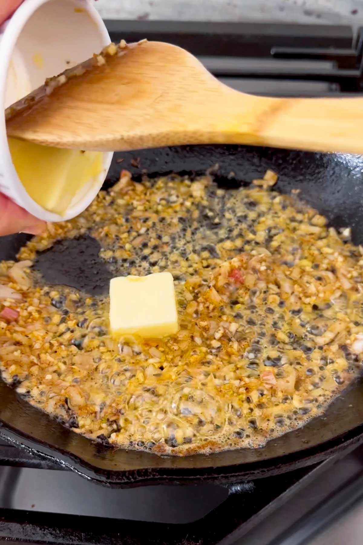 cooking garlic, shallots, and butter in skillet