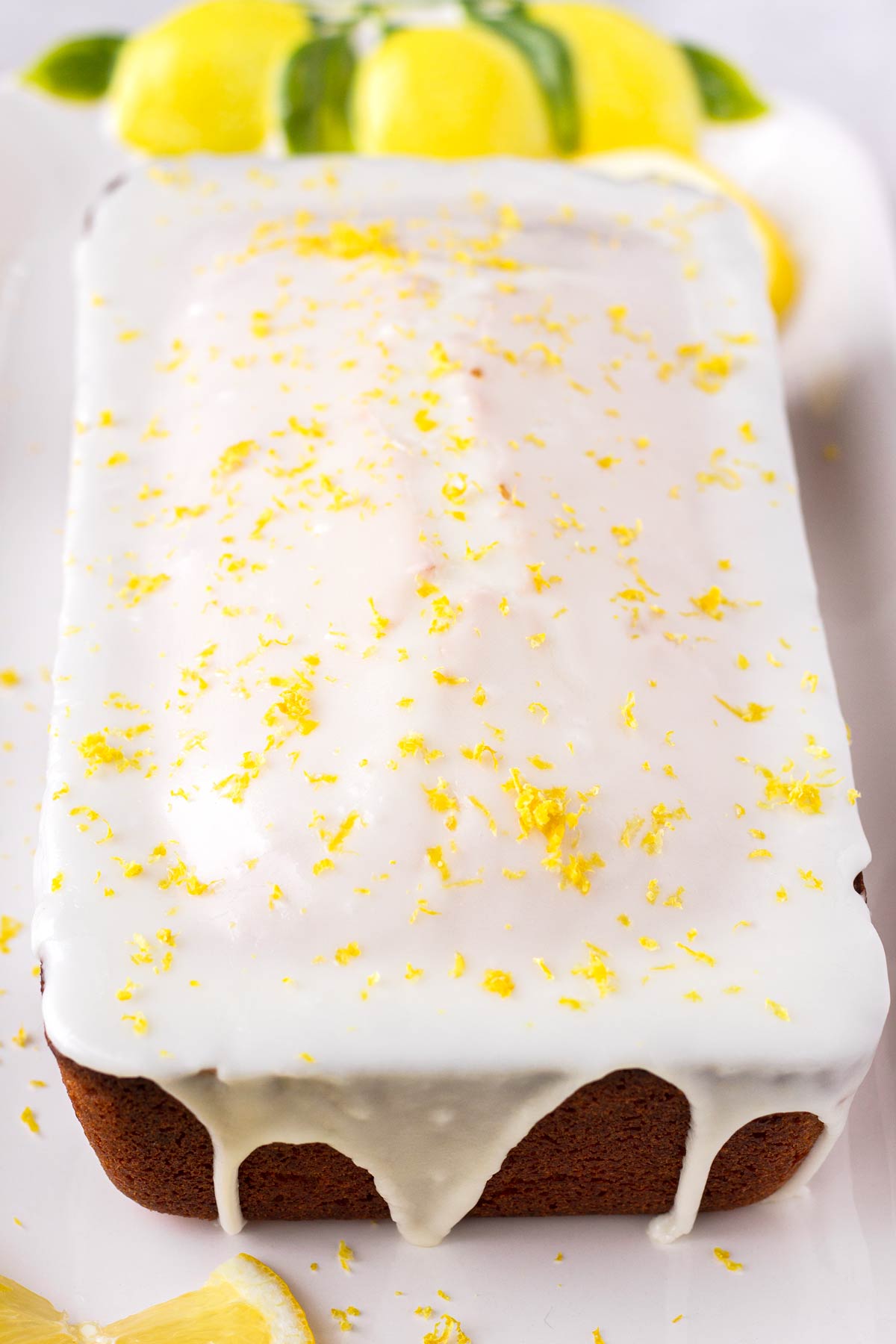 glazed lemon loaf cake with lemon zest on top