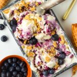 scooped blueberry cheesecake ice cream in its container