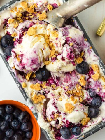 scooped blueberry cheesecake ice cream in its container