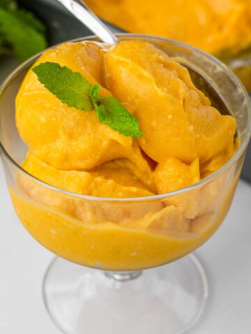 a serving of mango sorbet with mint garnish