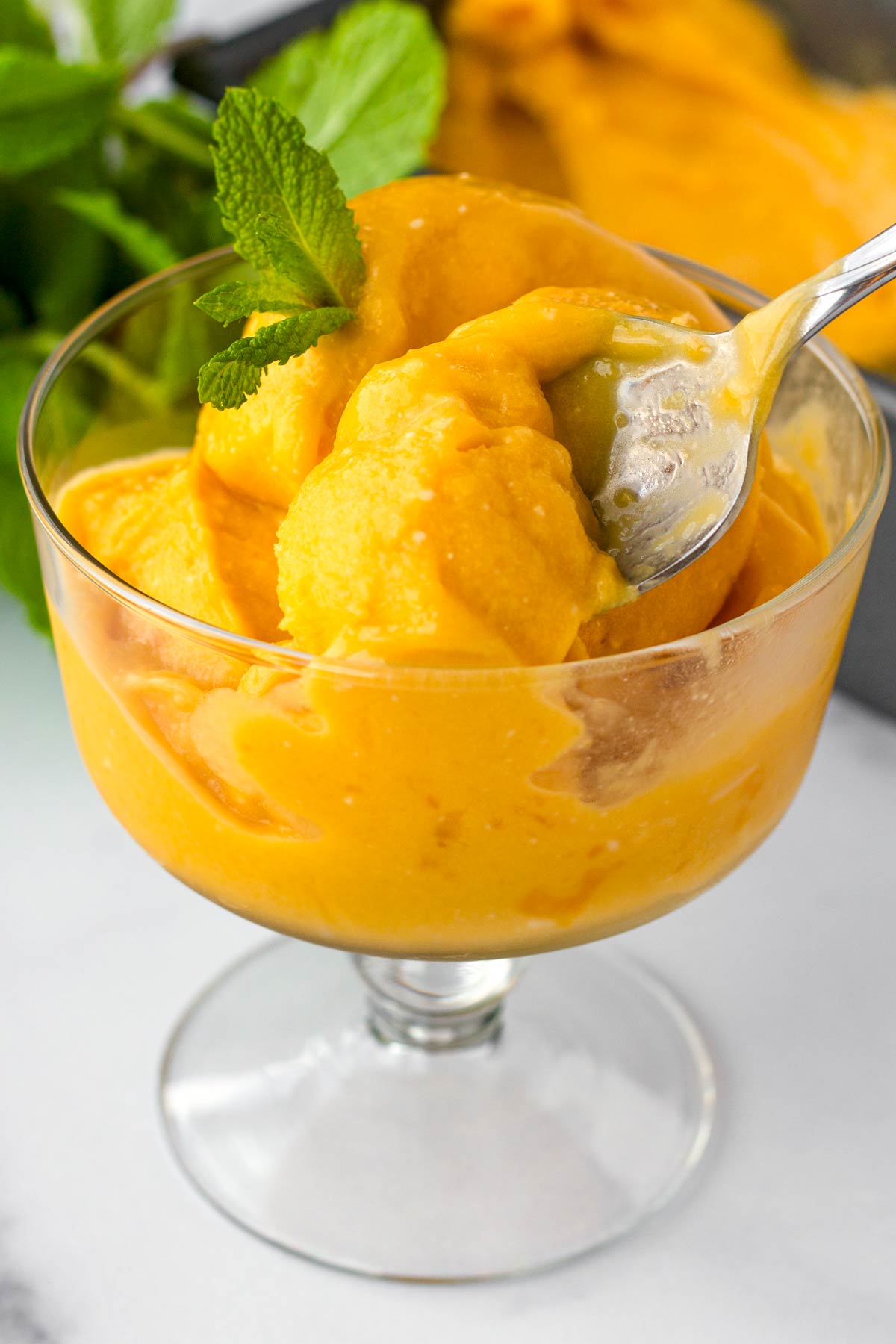 a spoonful of mango sorbet with coconut