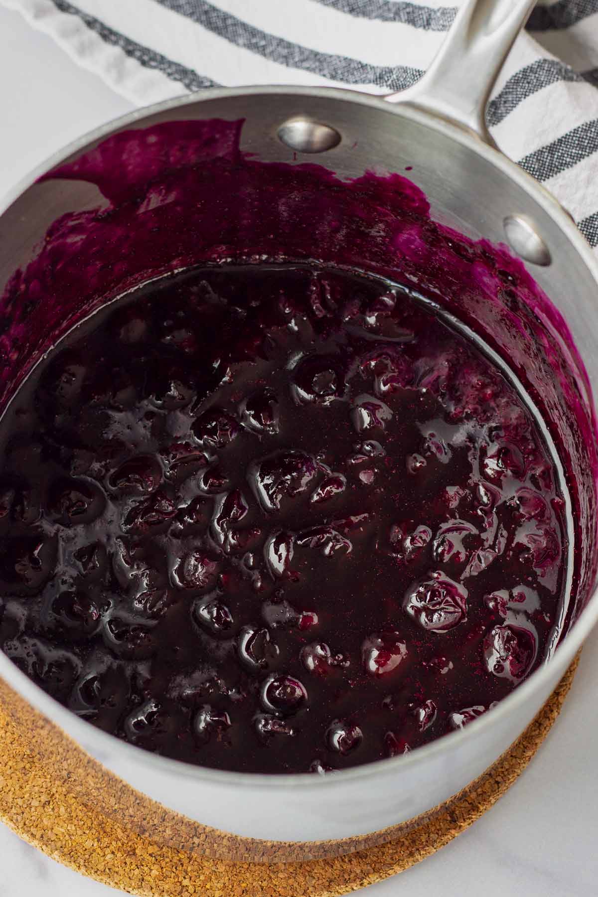 cooked down blueberry sauce in a saucepan