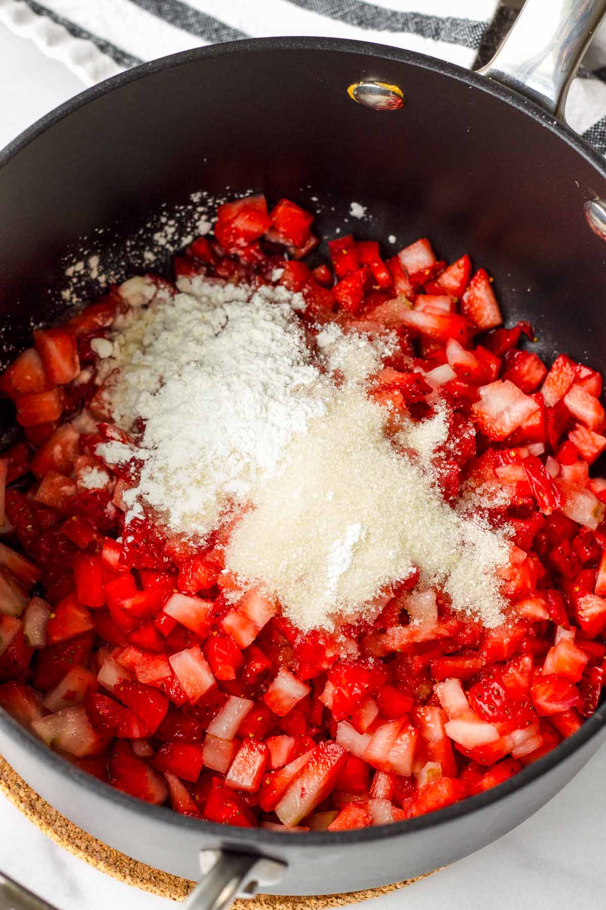 ingredients for the strawberry sauce combined in a saucepan