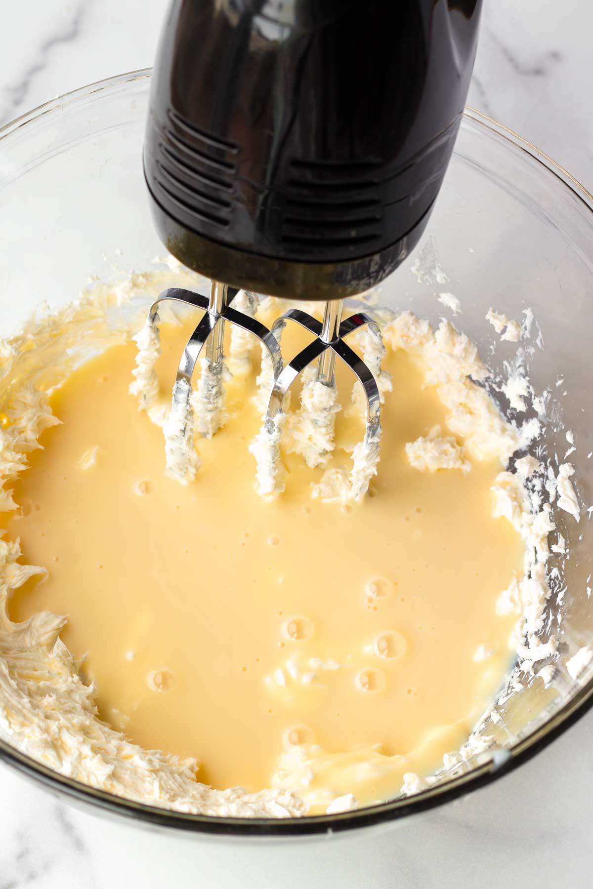 mixing the condensed milk and cream cheese
