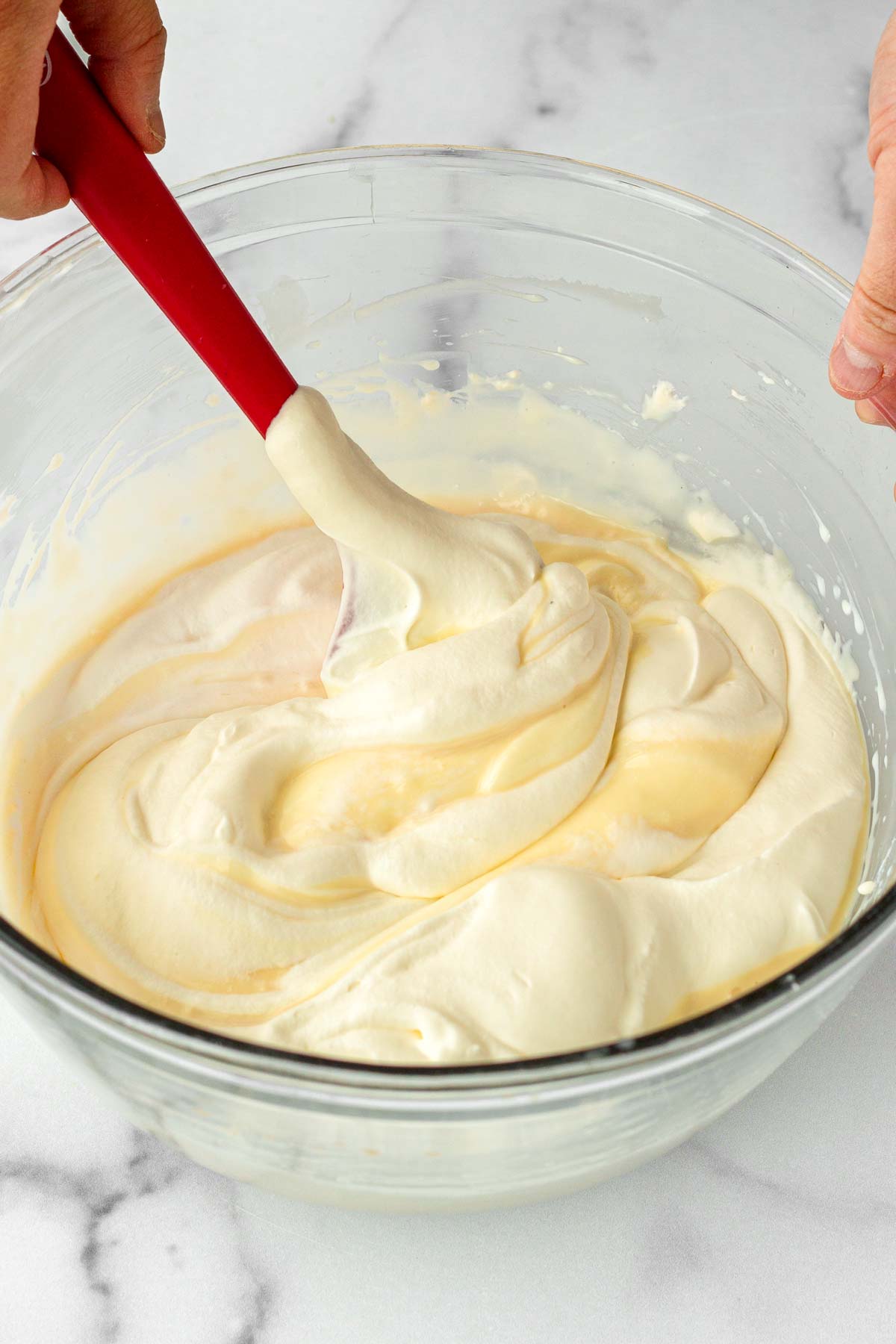 folding whipped heavy cream with the ice cream base