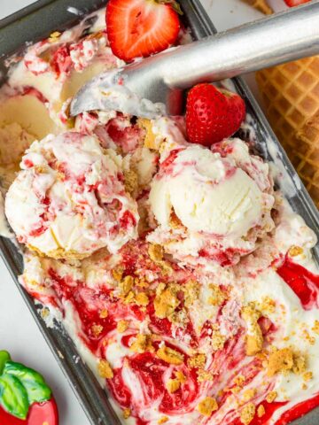 scooping out strawberry cheesecake ice cream from the container