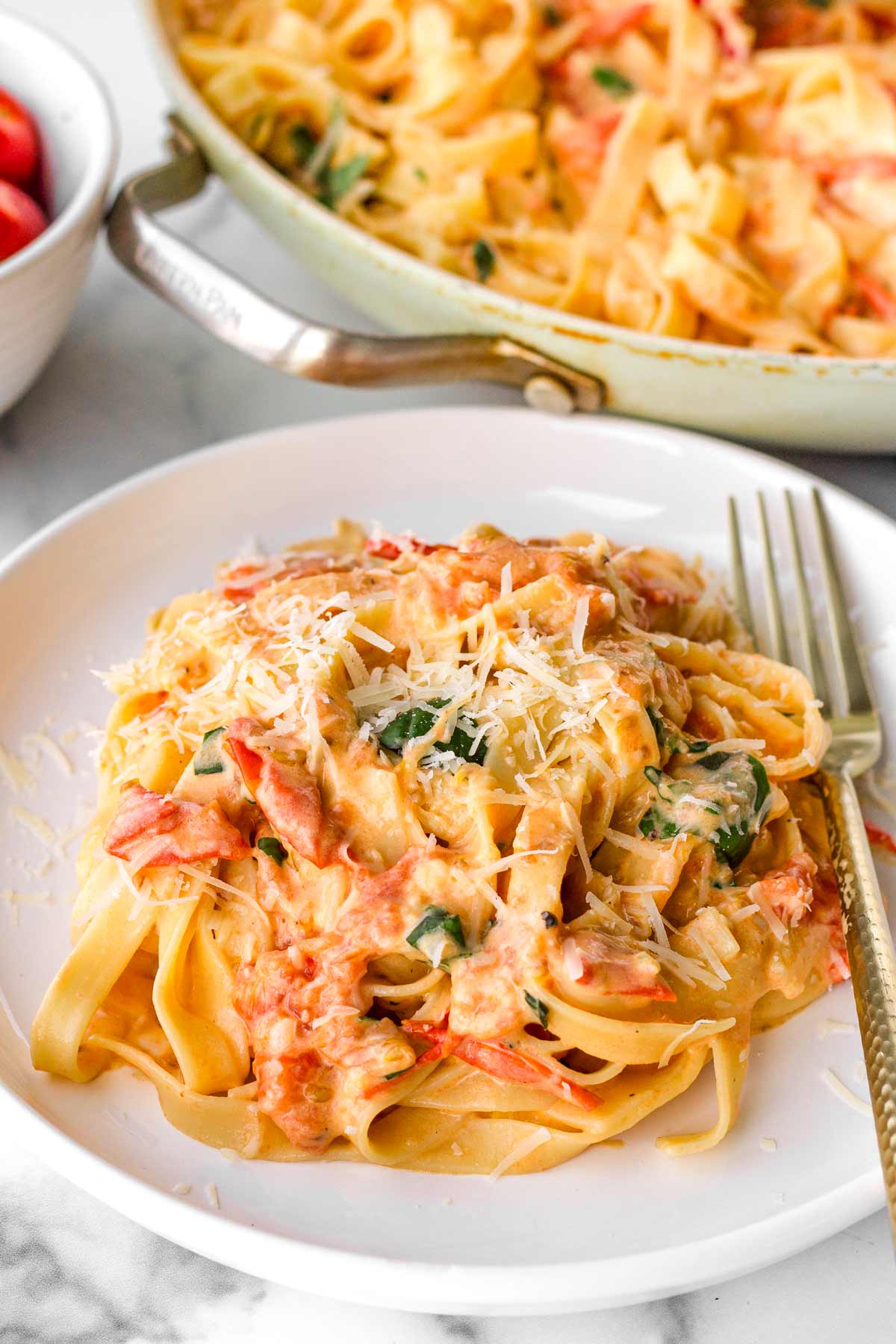 plate with creamy tomato pasta with a fork