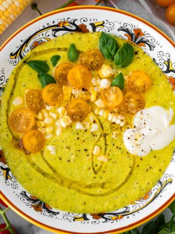 summer corn gazpacho with tomato, basil, and cream garnish