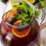 blackberry iced tea with fresh fruit inside of the pitcher