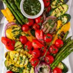 platter with beautiful and colorful grilled vegetables and herb sauce