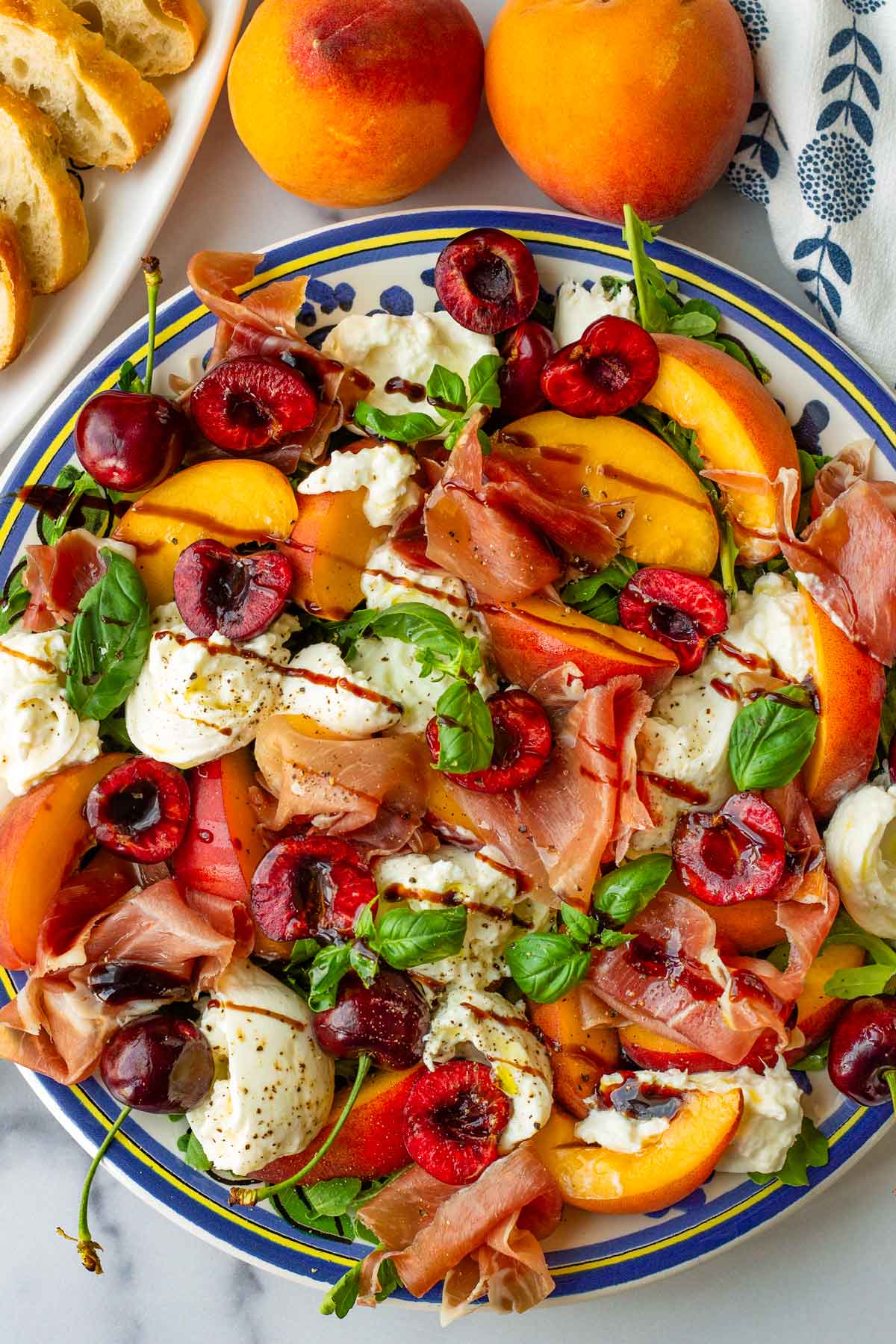 platter of peach burrata salad with toasted baguette slices