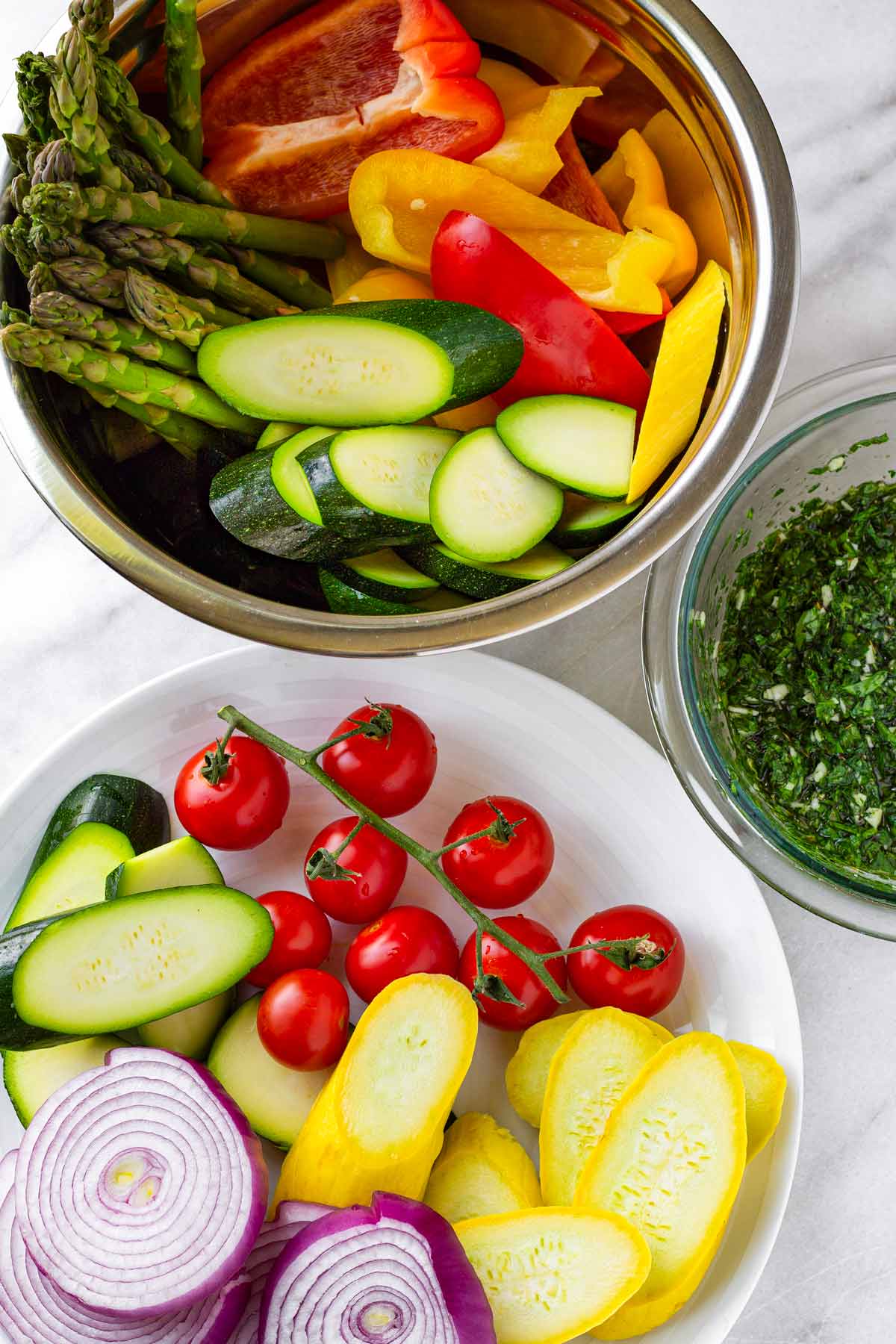 sliced vegetables and sauce in bowls ready for the grill