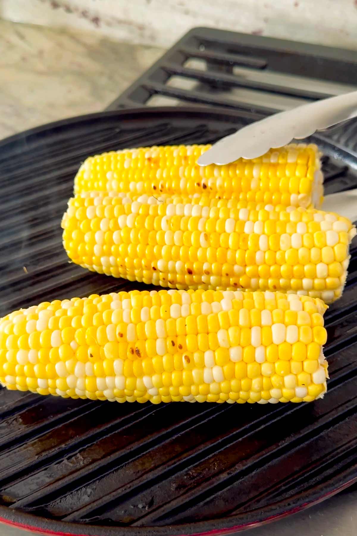lightly grilling corn on grill pan