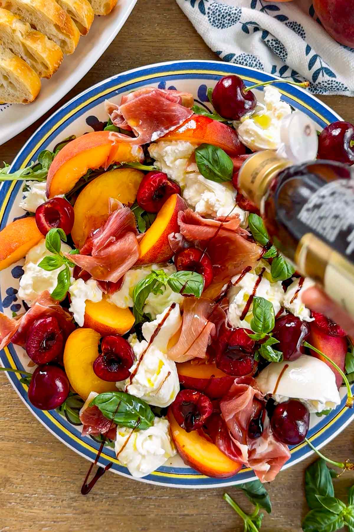 adding balsamic glaze drizzle to the salad