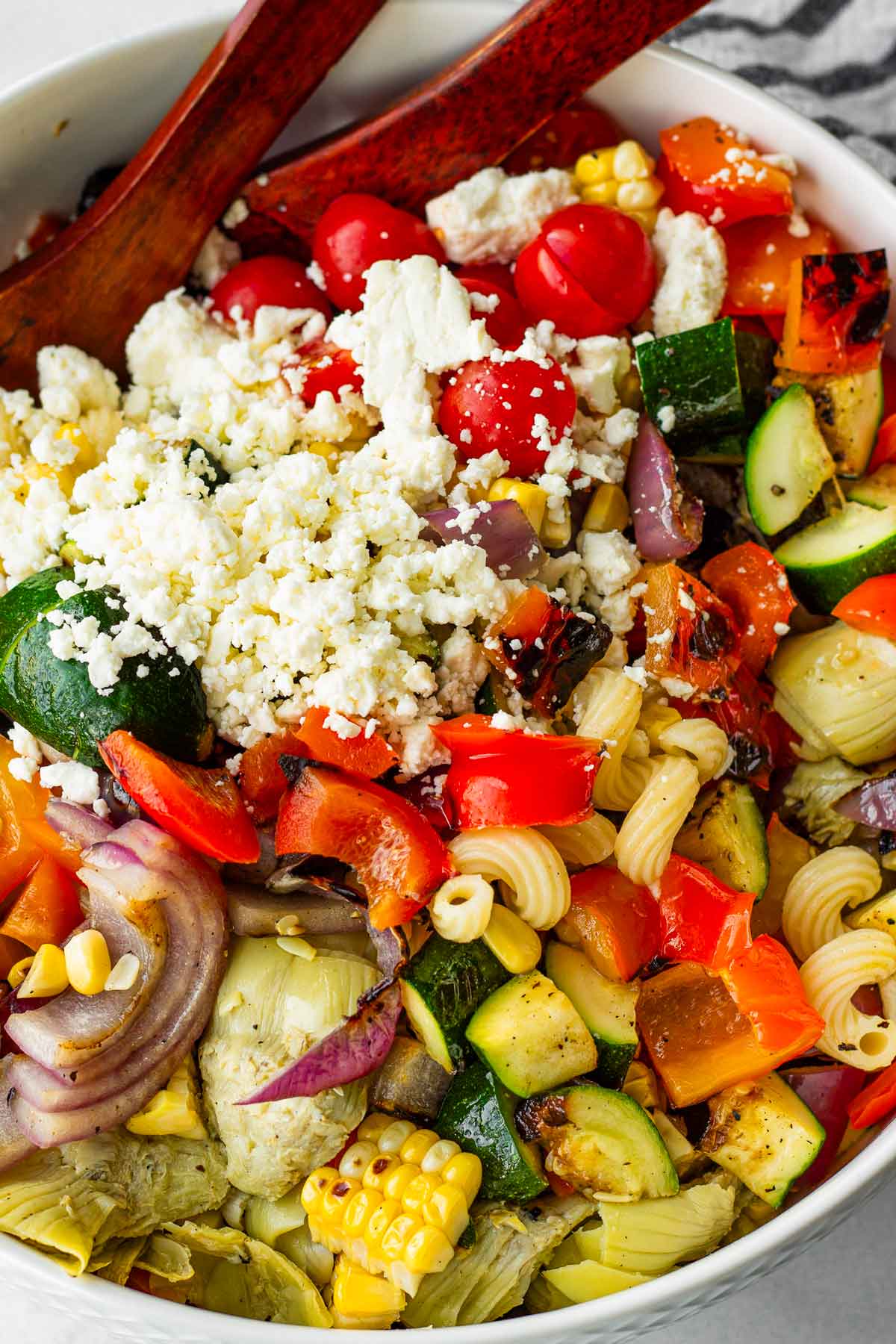 all grilled vegetable pasta salad ingredients assembled in a bowl