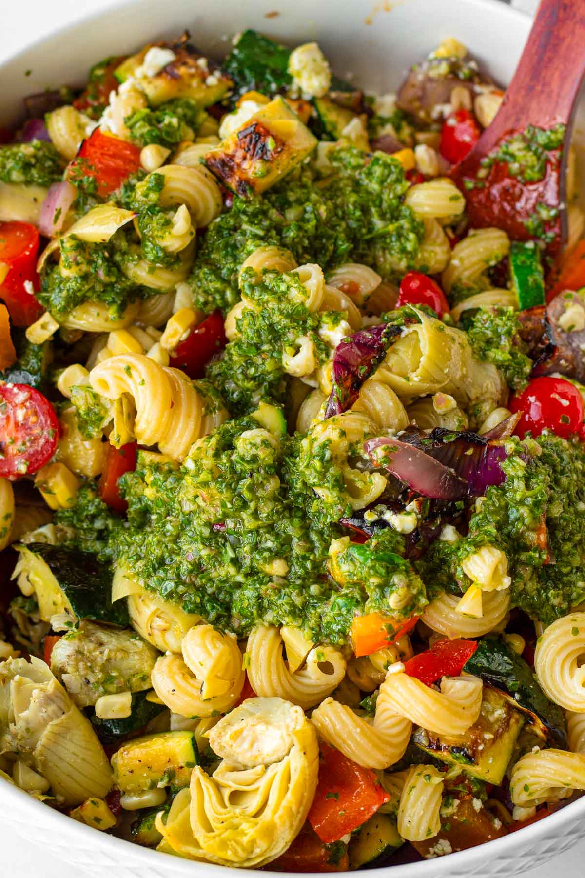 basil vinaigrette added on top of pasta salad