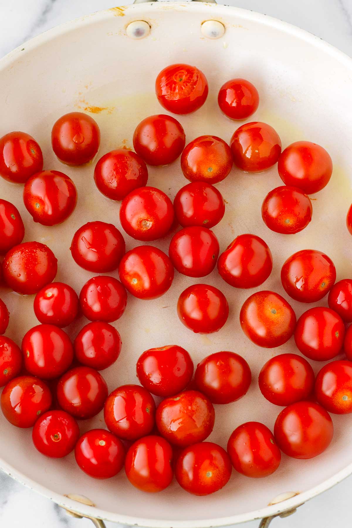 whole cherry tomatoes in a skillet