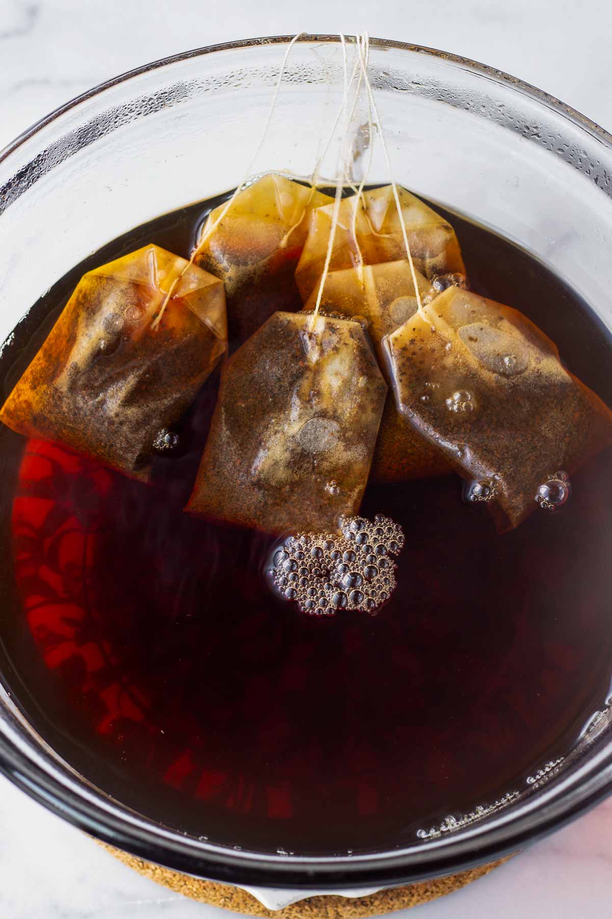 seeping six bags of black tea in hot water