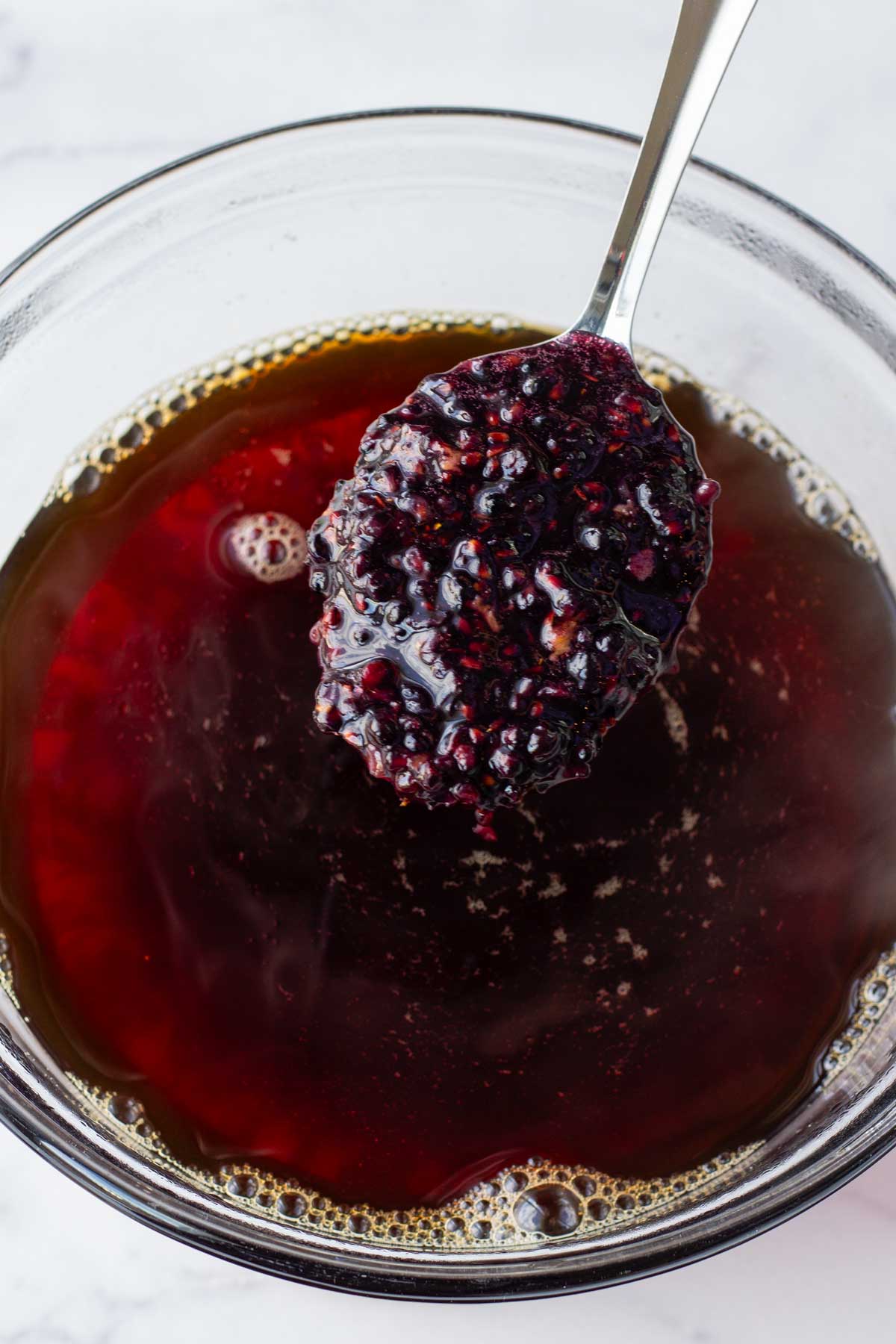 adding macerated blackberries into the brewed tea