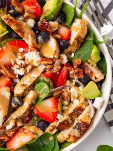 strawberry chicken salad with spinach, pecans, and feta
